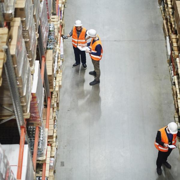 Warehouse workers in aisle