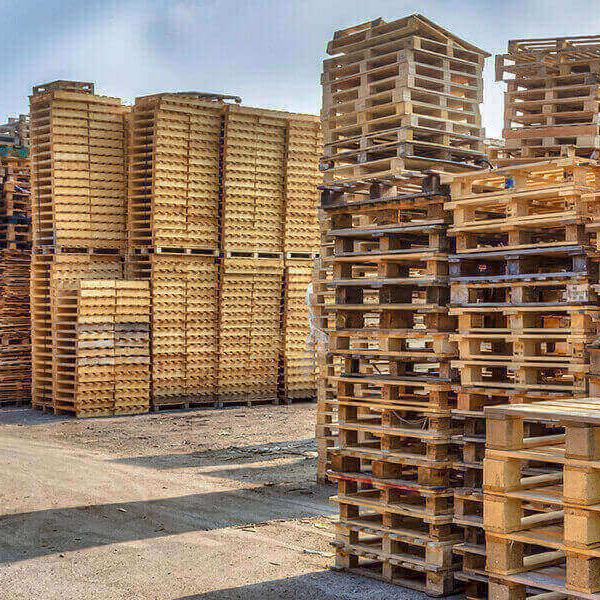 large stacks of pallets in a yard