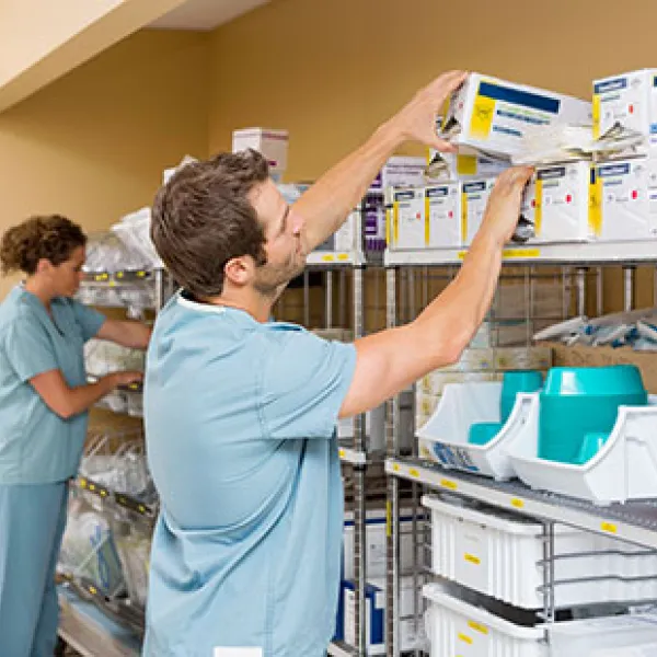 Male nurse preparing clinical supplies for an operation