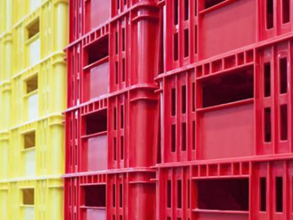 Red and yellow tote boxes are stacked into place