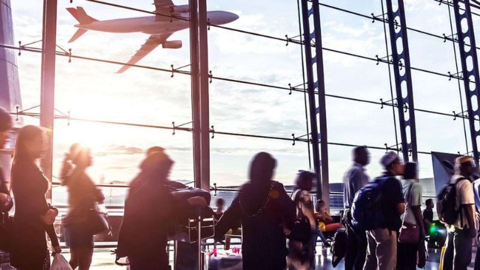 A busy airport with a plane taking off in the background